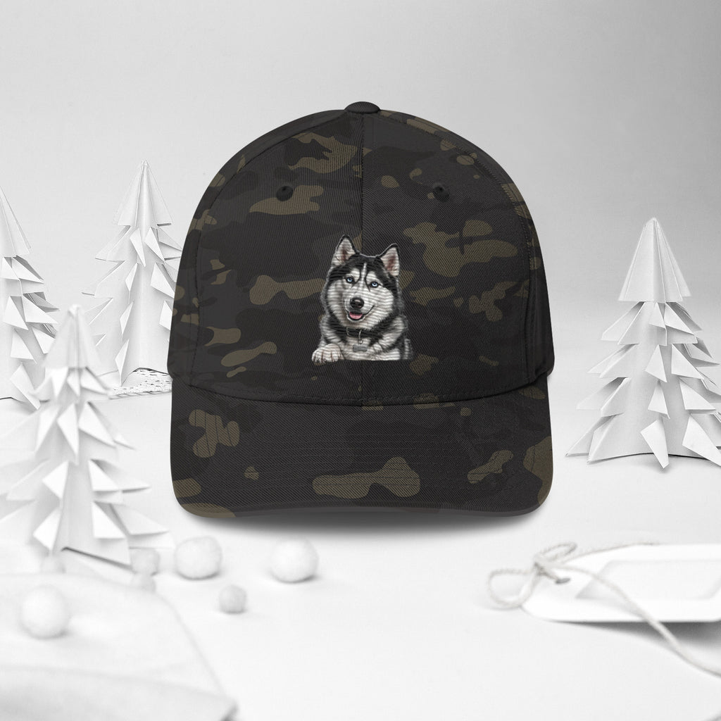 Sheldon the husky front and centre on a multicam black structured twill cap, front view