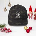 Sheldon the husky front and centre on a multicam black structured twill cap, front view