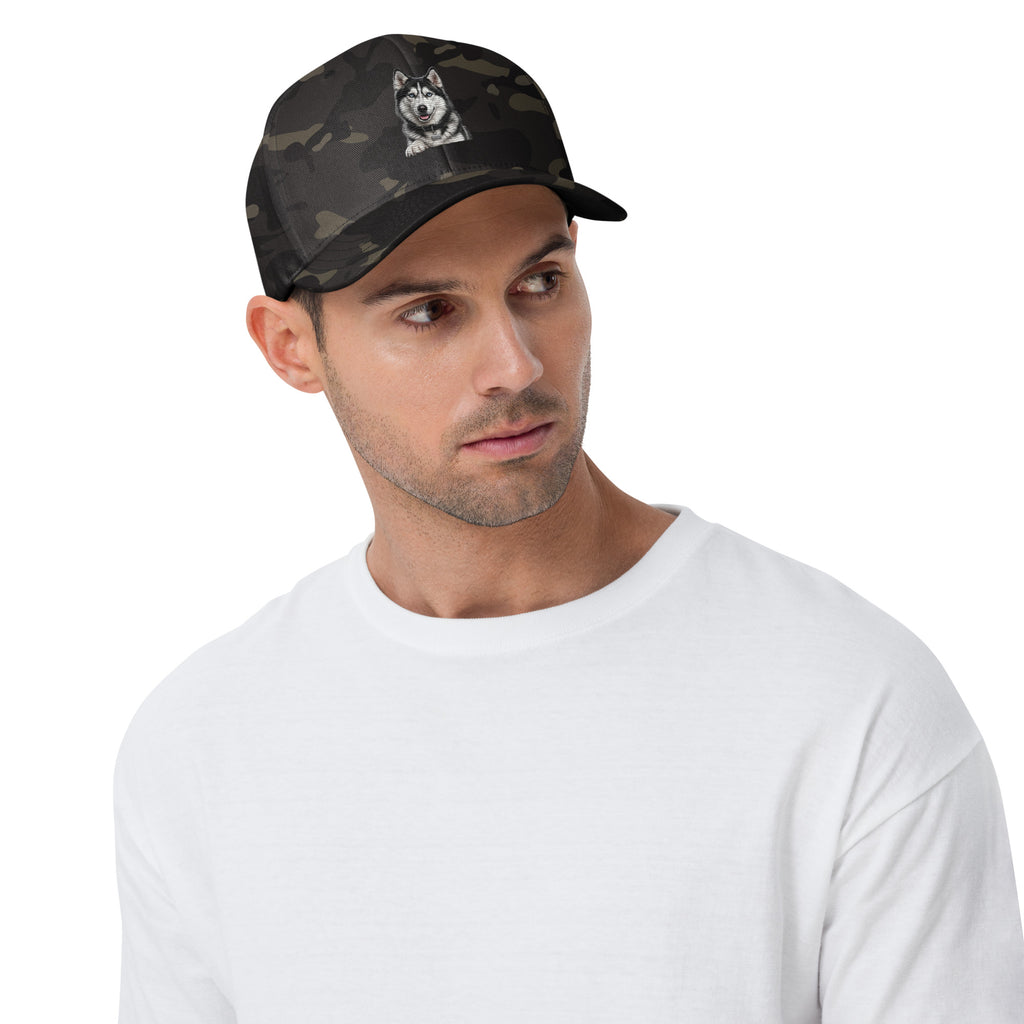 Sheldon the husky front and centre on a multicam black structured twill cap, front view